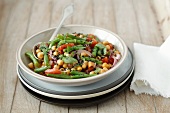 Chickpea salad with green beans, tomatoes, onions and mint