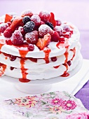 Pavlova with fresh berries on a cake stand