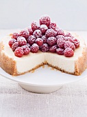 Cheesecake topped with fresh raspberries, sliced