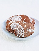 Chocolate biscuits with iced lace decoration