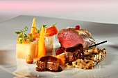 Saddle of venison on a bed of chanterelles with a side of vegetables