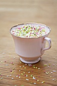 A cup of colourful sugar sprinkles