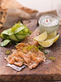 Filleted char with dill flowers, remoulade, cucumber slices and lemon wedges