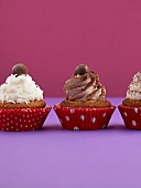 Three cupcakes with various toppings