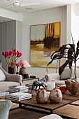 Modern living room furniture combined with hot pink flowers and horse figurine on coffee table