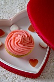 A Pink Frosted Cupcake in a Heart Shaped Box for Valentine's Day
