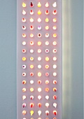 Modern, flat light sculpture with dots of light