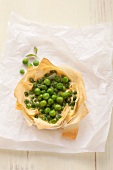A puff pastry dish filled with peas