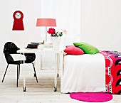 Colourful pillows and bedspread in white bedroom