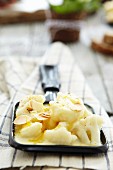 Cauliflower raclette with sliced almonds