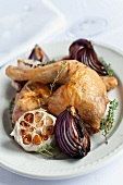 Chicken legs with thyme, garlic and red onions