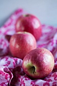 Pink Lady apples on a white cloth