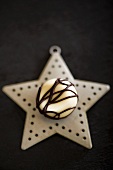 A white chocolate praline on a Christmas star