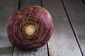 A turnip on a wooden surface
