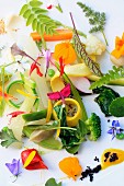 Chopped vegetables and flowers on a white plate