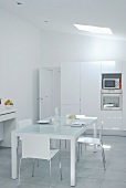Minimalist white kitchen - all materials are white or made of glass