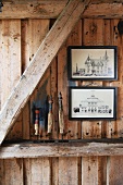 Pictures hanging on wooden wall, ornaments on wooden beams