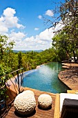 Wooden terrace with curved pool and fabulous view across landscape