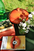 Books, flowers and pot on garden table