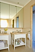 Bright bathroom with separate wash stands and mirrored bathroom cabinet