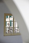 Restricted view of historic facade of country manor (Schloss Schauenstein) through lattice window