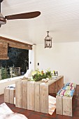 Spring arrangement on rustic outdoor table and wooden benches in loggia