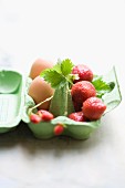 Strawberries and eggs in an eggbox
