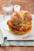 Schnitzel roll with lettuce, tomato and edible shoots