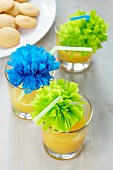 Drinking straws decorated with tissue paper pompoms
