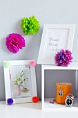 Pompoms decorating picture frames & wall