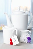 Milk jugs decorated with labels & pompoms