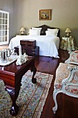 Colonial-style antiques in grand bedroom