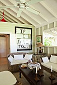 Colonial-style coffee table and rattan sofa set in white wooden cabin