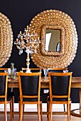 Elegant dining area with classic, leather covered chairs, crystal candelabra and gilt-framed mirrors