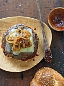 Cheeseburger with Caramelized Onions and Barbecue Sauce; Top Bun Removed; From Above