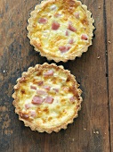 Two Quiche Lorraine on a Wooden Table