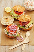 Home-made burgers with surimi salad, tomato, lettuce and red onion