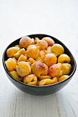 Frozen mirabelle plums in a bowl