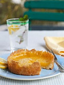 Individual Lemon Tart on an Outdoor Table; On a Blue Plate with a Fork