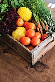 Vegetables and lemons in vintage wooden crate