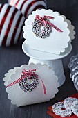 White, cloud-shaped, festive cardboard gift boxes with sugar sprinkle rings