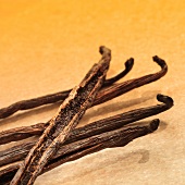 A number of vanilla pods on yellow stone