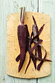 Peeled purple carrot on a chopping board