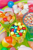 Assorted colourful sweets (jelly sweets, chocolate beans, marshmallows and lollipops)