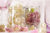 Beads and pink hydrangeas in jars