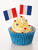 A cupcake decorated with buttercream and French flags