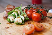 Tomatoes with mozzarella and basil skewers