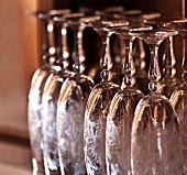 Upside-down cut-glass champagne flutes on a shelf