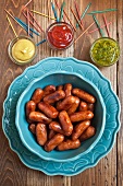 Cocktail Franks in a Blue Bowl with Bowls of Ketchup, Mustard, and Relish for Dipped; Toothpicks