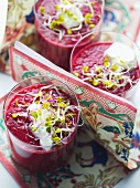 Beetroot juice garnished with shoots and sour cream
